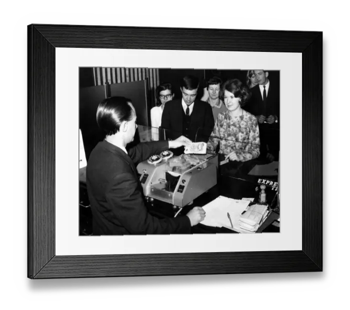 Framed Print : May 1st 1967 Bank teller Mr William Treacy loading pound notes into the machine