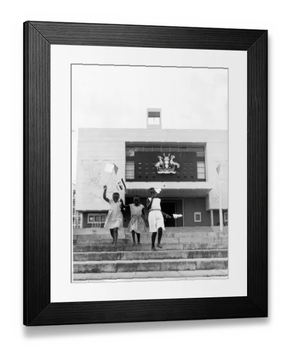 Framed Print : Kampala, Uganda: Three young girls run down the steps in front of the new Parliament building here