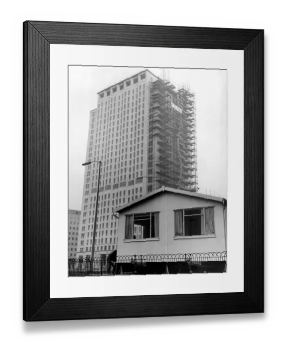 Framed Print : Dwarfed by the new Shell skyscraper is the sun cottage. One of three new portable Framed Print : Dwarfed by the new Shell skyscraper is the sun cottage. One of three new portable
