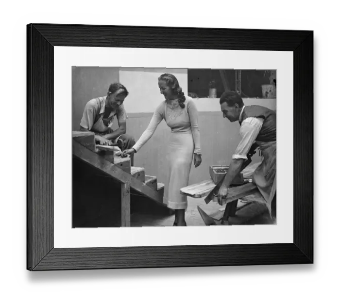 Framed Print : Miss Elmina Humphreys, the radio Queen, holding a nail for one of the workmen building Framed Print : Miss Elmina Humphreys, the radio Queen, holding a nail for one of the workmen building