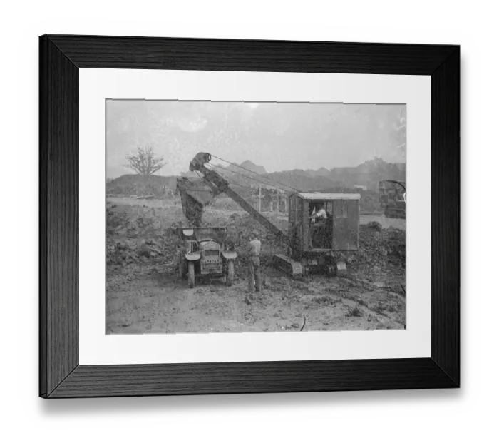 Framed Print : A mechanical navvy carrying away the spoil during the excavations on the site of Framed Print : A mechanical navvy carrying away the spoil during the excavations on the site of
