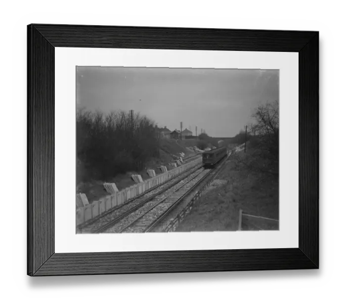 Framed Print : A train is going past the site where the Albany Park Train Station is under construction Framed Print : A train is going past the site where the Albany Park Train Station is under construction