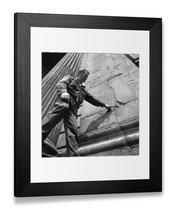 Framed Print : A worker points out the cracks that need repairing to the exterior wall of St Pauls Cathedral Framed Print : A worker points out the cracks that need repairing to the exterior wall of St Pauls Cathedral