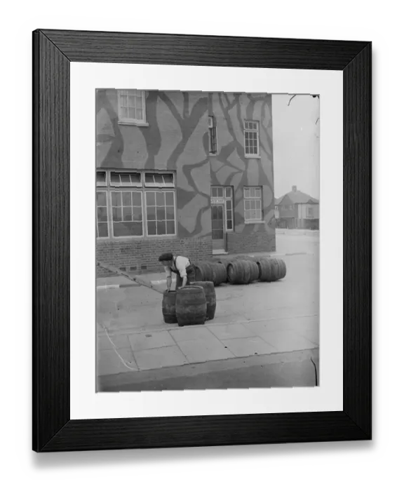 Framed Print : Taking in a barrel delivery outside The Northover, a camouflaged public house in Framed Print : Taking in a barrel delivery outside The Northover, a camouflaged public house in