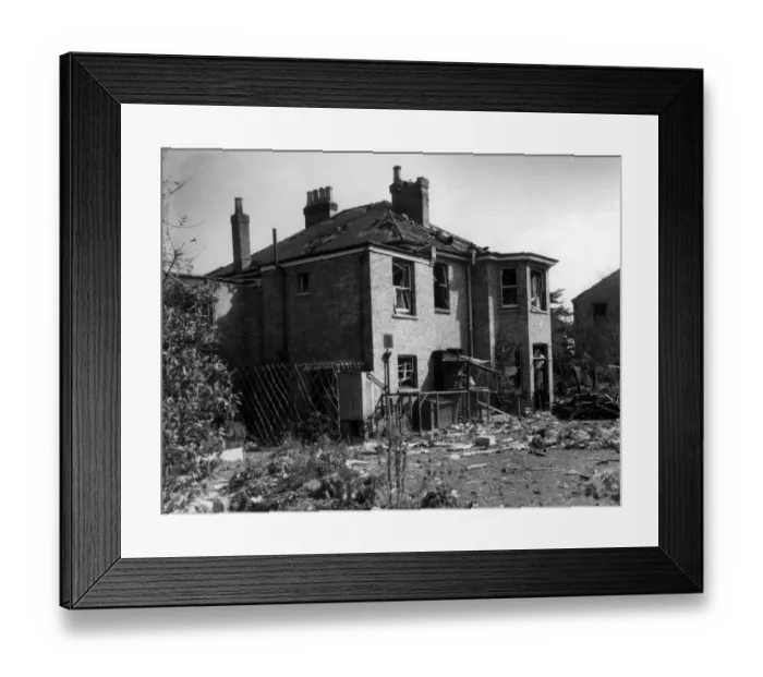 Framed Print : A house in the Bexley area, showing considerable damage, surrounded by debris after