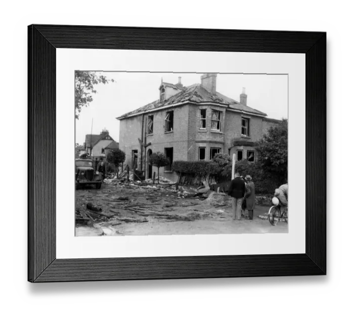 Framed Print : A house showing considerable damage, surrounded by debris after a near miss