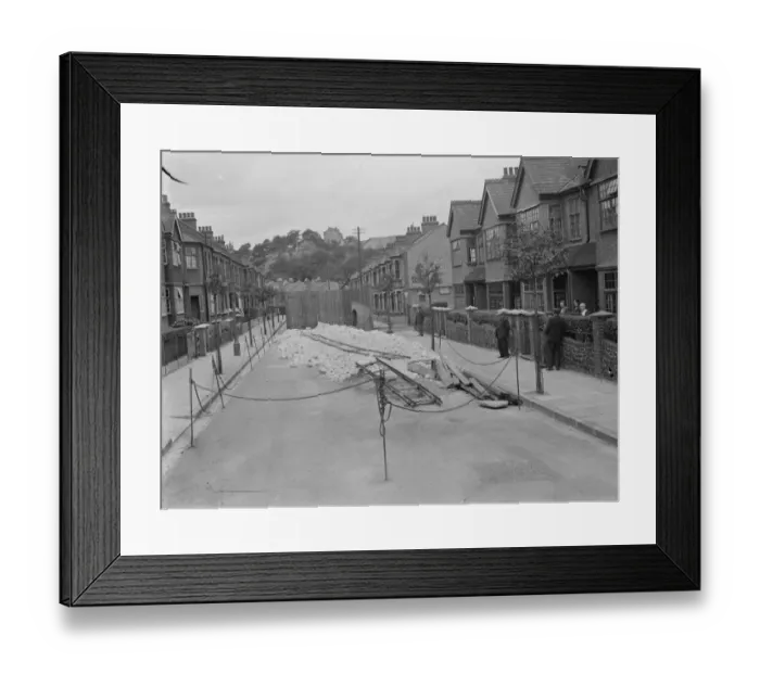 Framed Print : Residents of a street in Plumstead look at what is left of their road following some subsidence