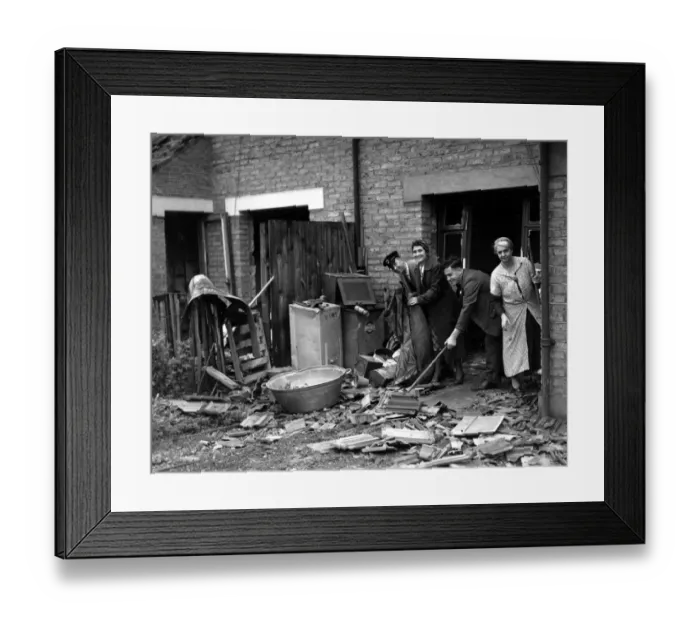 Framed Print : Home front 1940 A bus driver cleans debris from an air raid up before reporting