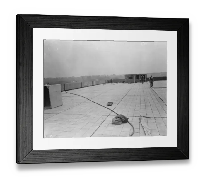 Framed Print : Workers from Val De Travers Asphalt Limited, a paving company, working on a roof in Greenwich Framed Print : Workers from Val De Travers Asphalt Limited, a paving company, working on a roof in Greenwich