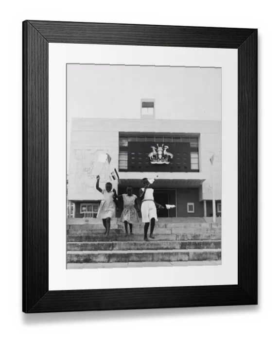 Framed Print : Kampala, Uganda, three young girls run down the steps in front of the new parliament Framed Print : Kampala, Uganda, three young girls run down the steps in front of the new parliament