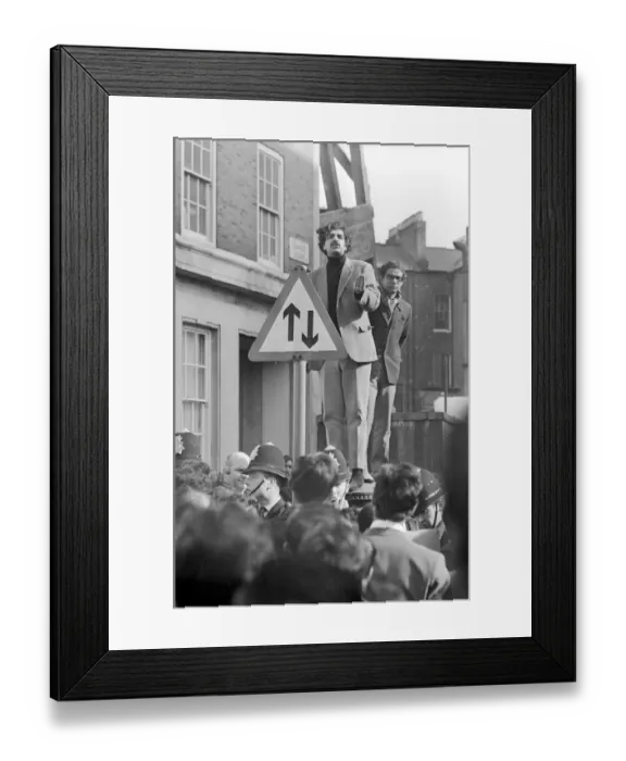 Framed Print : London: Pakistani-born student leader Tariq Ali stands a top pillar-box near