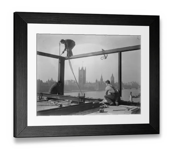 Framed Print : He looks down on Parliament. A welder on a precarious perch high above the Albert Embankment Framed Print : He looks down on Parliament. A welder on a precarious perch high above the Albert Embankment
