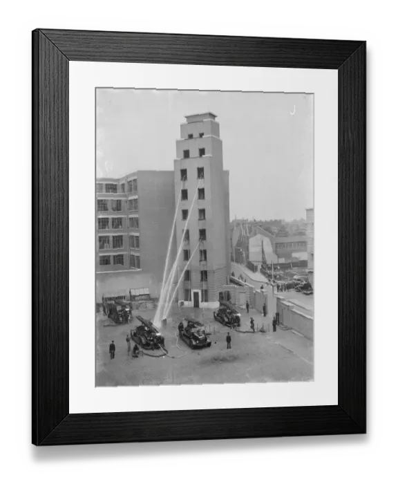 Framed Print : A London Fire Brigade display in Lambeth, London. Firemen hose down from the windows Framed Print : A London Fire Brigade display in Lambeth, London. Firemen hose down from the windows