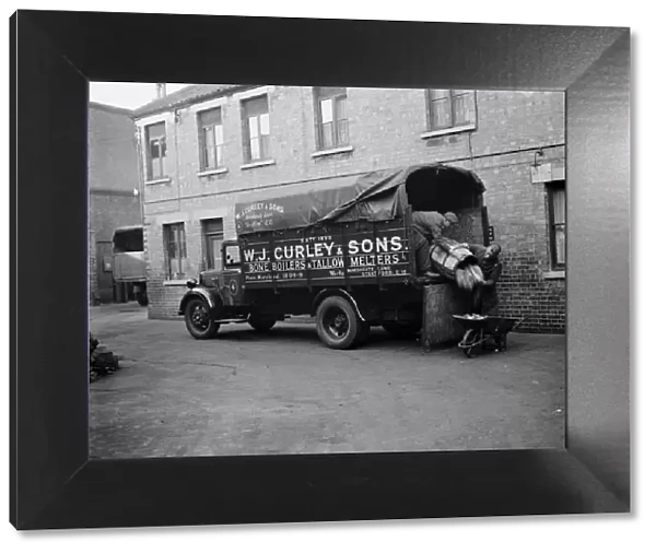 Men unloading bones and animal waste from a WJ Curleys lorry at Stratford, East London