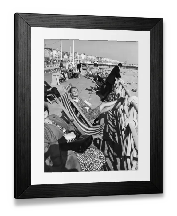 Framed Print : Brighton - enjoying the sunshine sitting in deckchairs on the Promenade at Brighton 28th