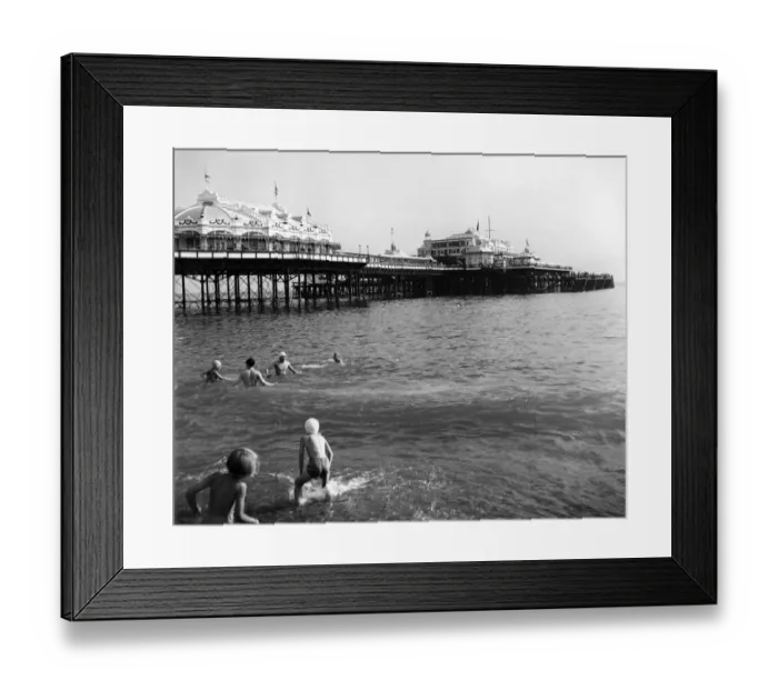 Framed Print : Brighton - enjoying paddling and swimming in the sea near the pier