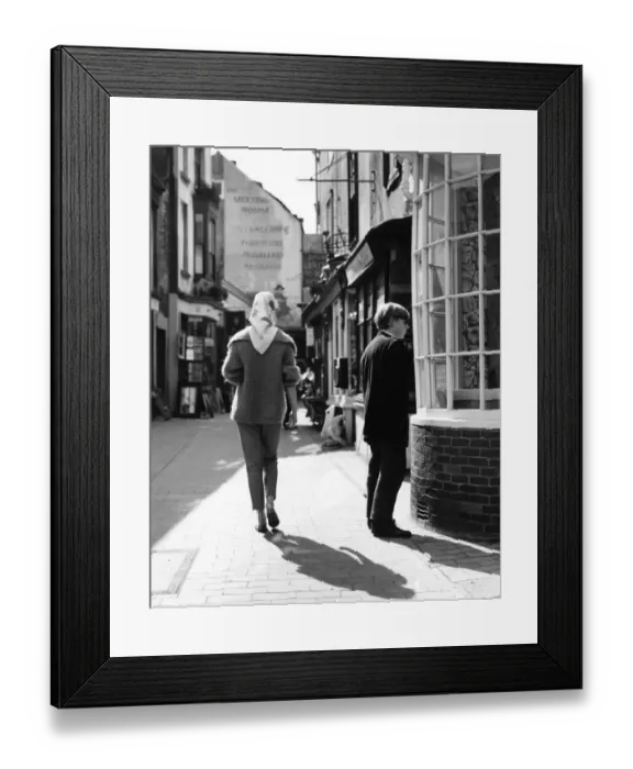 Framed Print : Rear view of woman wearing a mohair jumper and headscarf walking through the Lanes Framed Print : Rear view of woman wearing a mohair jumper and headscarf walking through the Lanes