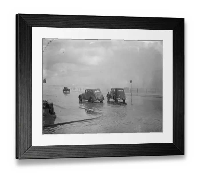 Framed Print : Wind, rain and sea lash Hastings. Heavy seas bursting over cars passing along Framed Print : Wind, rain and sea lash Hastings. Heavy seas bursting over cars passing along