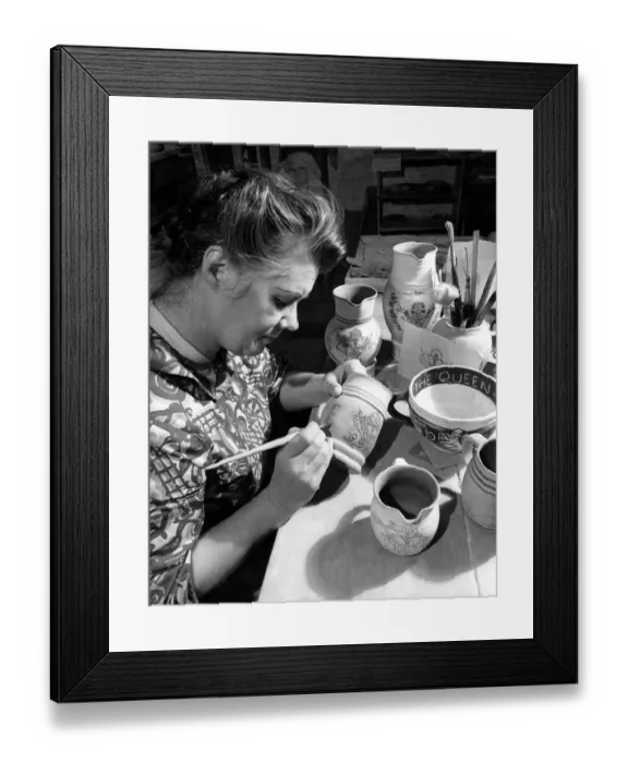 Framed Print : Mrs Rachel Warner using a brush to apply colour to the decoration engraved on a piece Framed Print : Mrs Rachel Warner using a brush to apply colour to the decoration engraved on a piece