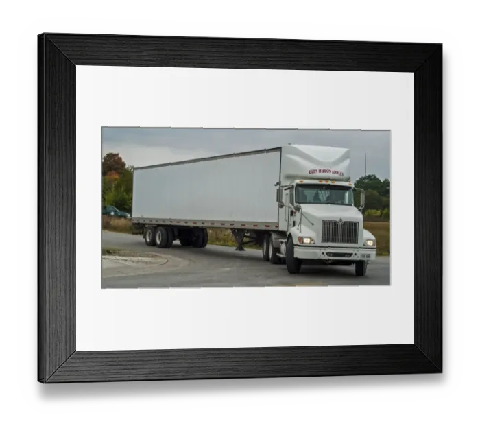 Framed Print : White International 6x4 semi tracter with a white twin axle box trailer turns right