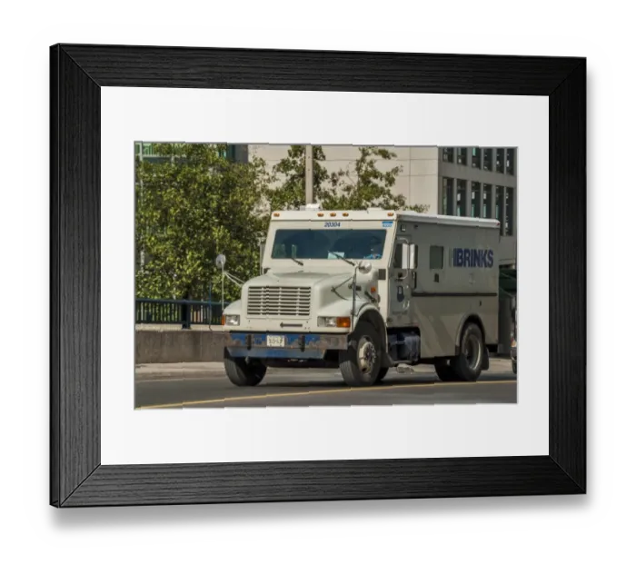 Framed Print : An International small 4 wheeled box van, amoured secuity vehicle in downtown toronto