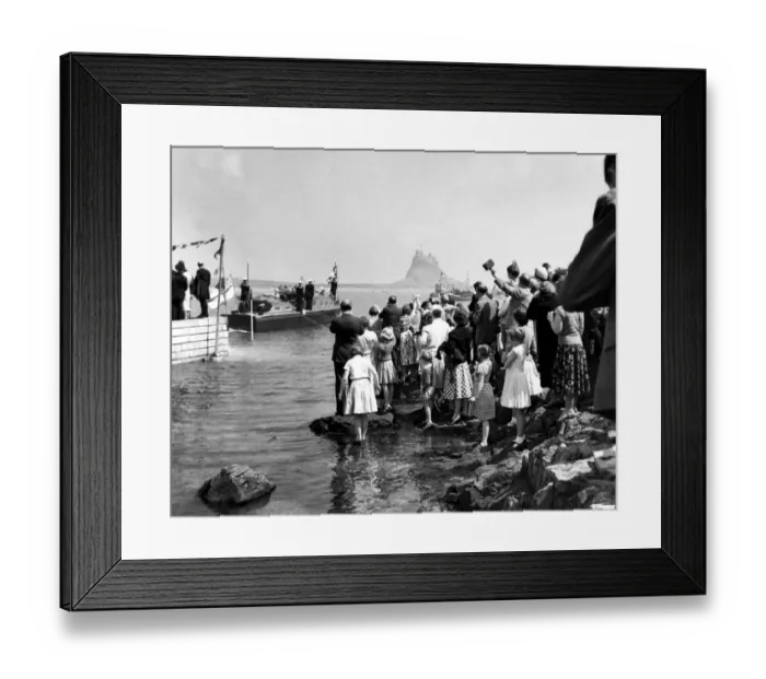 Framed Print : Crowds line the shore on Holy Island as the royal barge approaches the landing stae Framed Print : Crowds line the shore on Holy Island as the royal barge approaches the landing stae