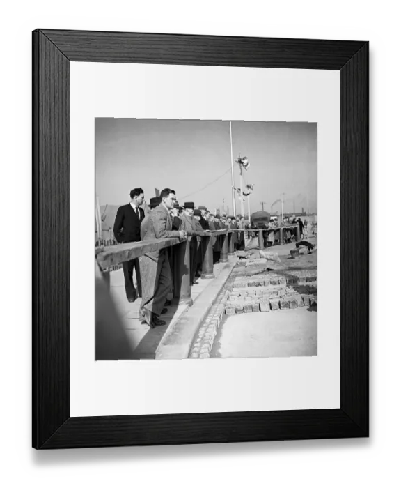 Framed Print : The rebuilding of Coventry City, England Citizens watch men at work, relaying