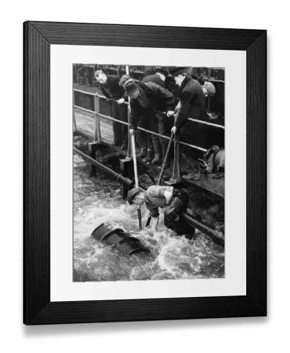 Framed Print : With his legs twisted round a pipe, Jock Kerr of Tottenham worked over the whirling