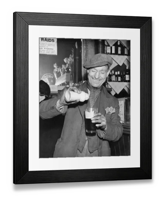 Framed Print : Man pours ground ginger in his pint of beer Framed Print : Man pours ground ginger in his pint of beer