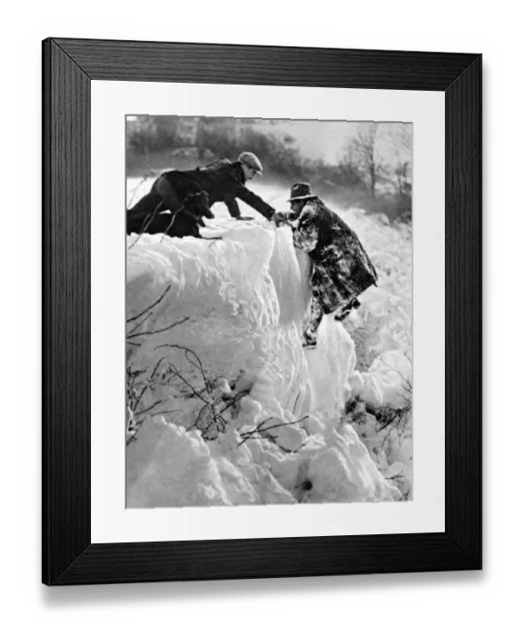 Framed Print : Southern England under snow a pedestrian rescued from a dangerous predicament near Framed Print : Southern England under snow a pedestrian rescued from a dangerous predicament near