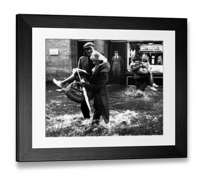 Framed Print : Helping hands in the Northern Floods office girls were carried through flood waters