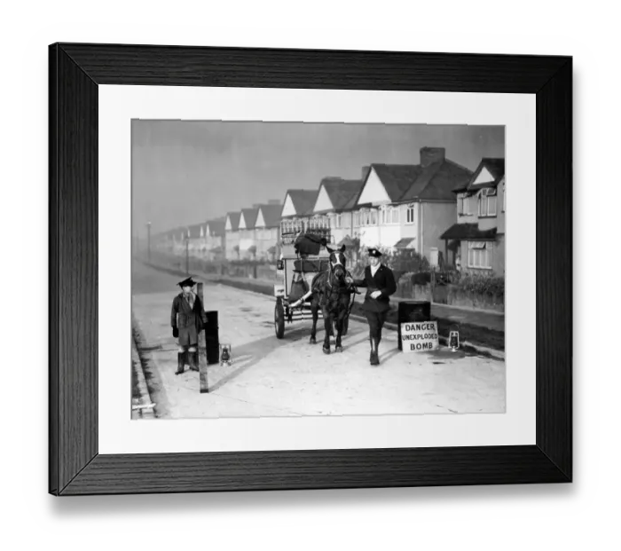 Framed Print : Milk man with his horse and float stands in a street where an unexploded bomb has