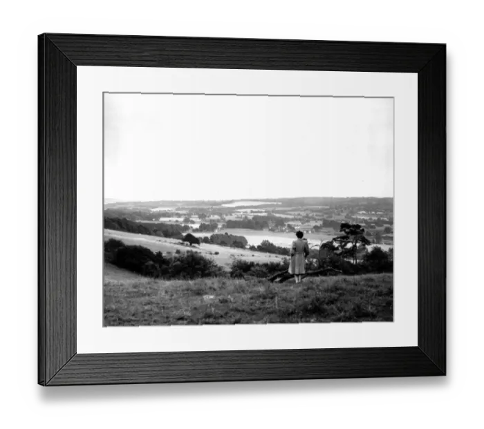Framed Print : A young woman admires a view across the Weald of Kent Framed Print : A young woman admires a view across the Weald of Kent