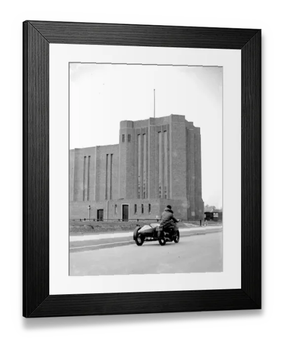Framed Print : A motorcycle riding past St Saviour Church in Eltham, Kent. 1934 Framed Print : A motorcycle riding past St Saviour Church in Eltham, Kent. 1934