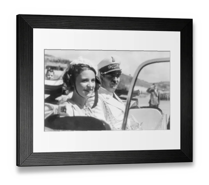 Framed Print : King Zog of Albania and his smiling young Queen, Geraldine, driving away after attending