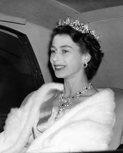 Queen Elizabeth II jewels glittering in her hair and at her throat arrives at Swedish
