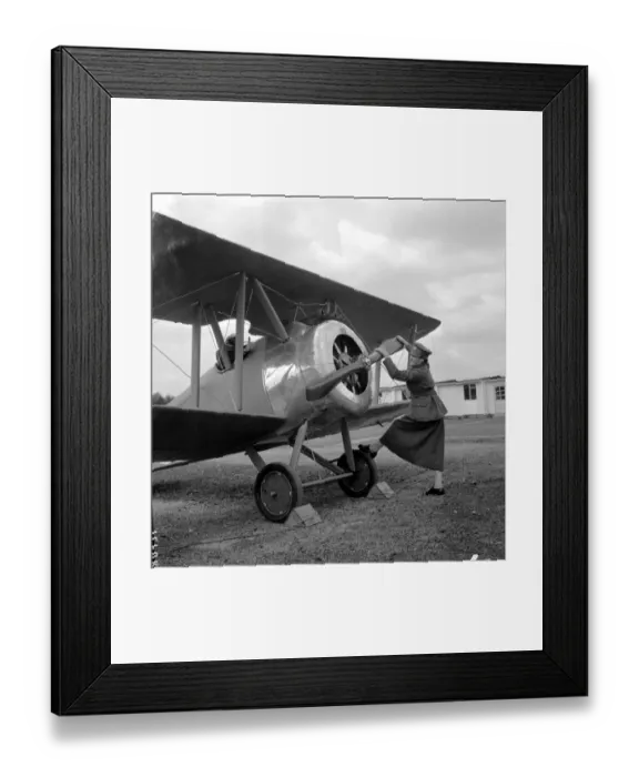 Framed Print : Swinging the propeller of a Sopwith Camel Plane is Irene Griffiths wearing the old Framed Print : Swinging the propeller of a Sopwith Camel Plane is Irene Griffiths wearing the old