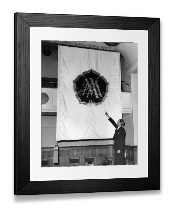 Framed Print : A Ministry of Works Official examining one of the banners, which will be used in Framed Print : A Ministry of Works Official examining one of the banners, which will be used in