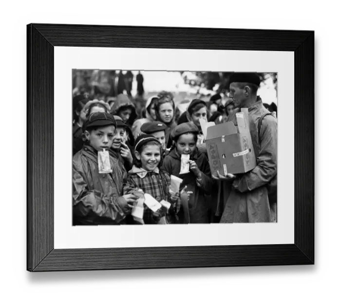 Framed Print : On the embankment children wait to watch the Coronation procession are issued with Framed Print : On the embankment children wait to watch the Coronation procession are issued with