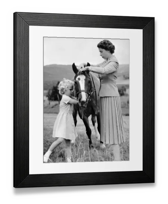 Framed Print : Princess Anne helps her mother Queen Elizabeth to adjust the bridle of the pony Greensleeves
