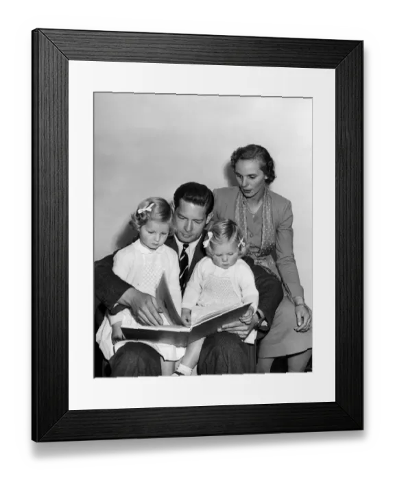 Framed Print : A bedtime story for Princess Margaret (3 1 / 2) and Princess Helen (2) is read by father Framed Print : A bedtime story for Princess Margaret (3 1 / 2) and Princess Helen (2) is read by father