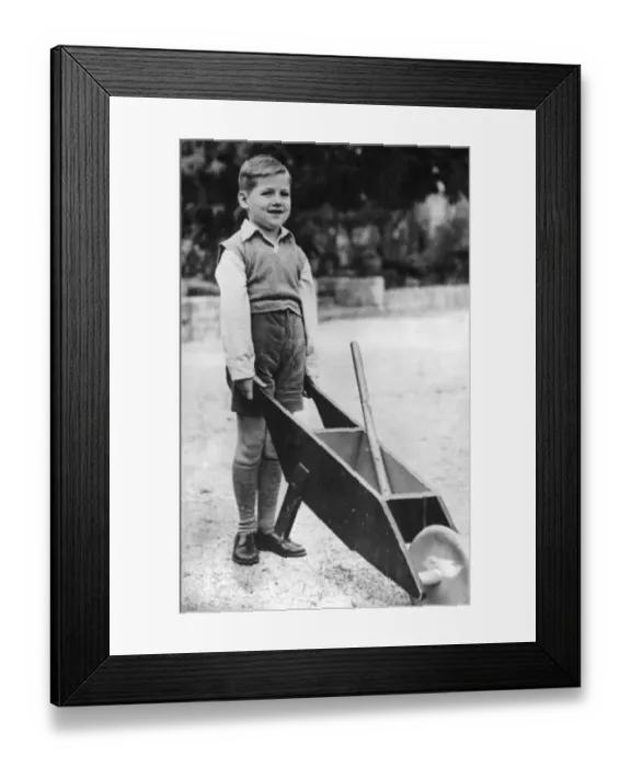 Framed Print : Crown Prince Constantine of Greece aged 6, with a wheelbarrow in the garden of the Royal Palace Framed Print : Crown Prince Constantine of Greece aged 6, with a wheelbarrow in the garden of the Royal Palace