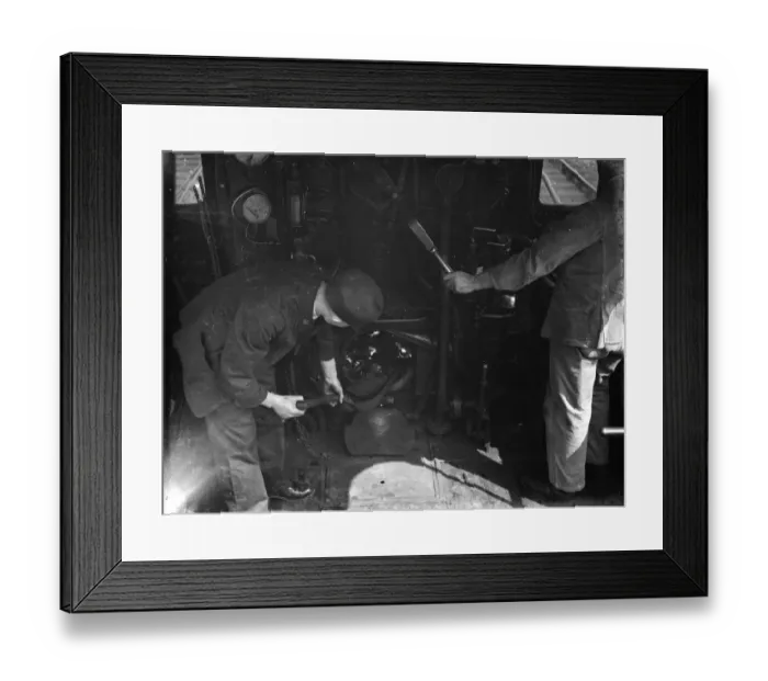 Framed Print : Inside a railway engine cabin. The fireman shovels coal into the fire. 1938 Framed Print : Inside a railway engine cabin. The fireman shovels coal into the fire. 1938