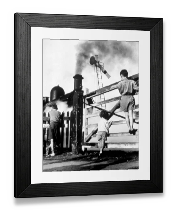 Framed Print : Steam train - children climbing gate to watch steam train go by - signal is down Framed Print : Steam train - children climbing gate to watch steam train go by - signal is down