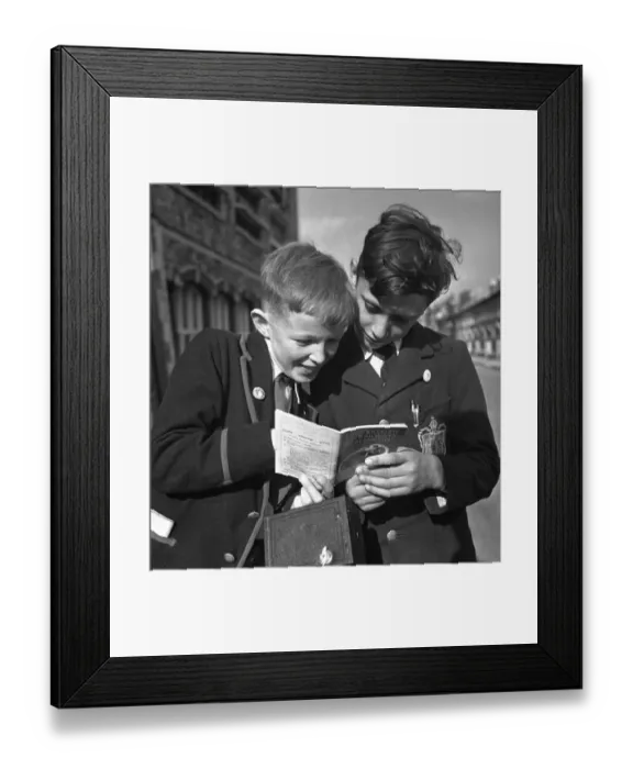 Framed Print : Trainspotters Club Outing. Two young trainspotters consult the British Railways