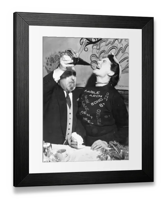 Framed Print : Olga Noble-Matthews drinks from a Spanish porron as she gathers some facts to add