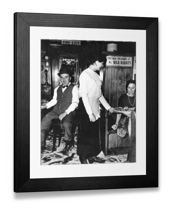 Framed Print : A waitress serves a booth at Flanagans restaurant near the Victoria and Albert Museum Framed Print : A waitress serves a booth at Flanagans restaurant near the Victoria and Albert Museum