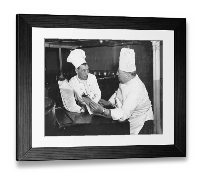 Framed Print : Queen Mary Chef Mr J. Pearce, assisted by second chef, Mr George Thomas (left) goes Framed Print : Queen Mary Chef Mr J. Pearce, assisted by second chef, Mr George Thomas (left) goes