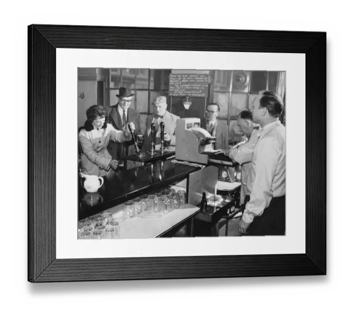 Framed Print : A woman customer pulls her own pint of beer at The Elephant and Castle, London, England Framed Print : A woman customer pulls her own pint of beer at The Elephant and Castle, London, England
