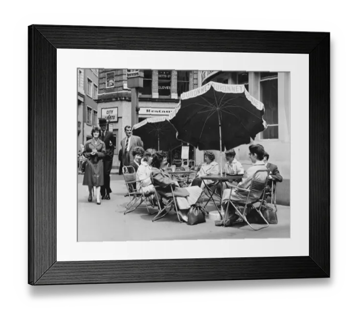 Framed Print : Office girls take their lunch break al fresco in a continental style table and umbrella Framed Print : Office girls take their lunch break al fresco in a continental style table and umbrella